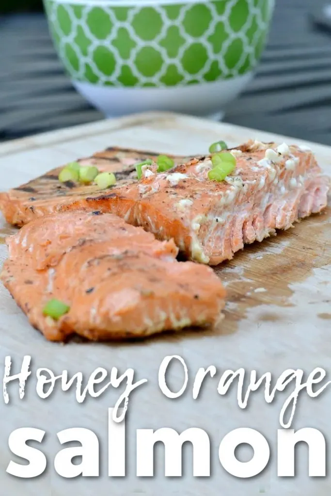 salmon cutting board with green chives on top