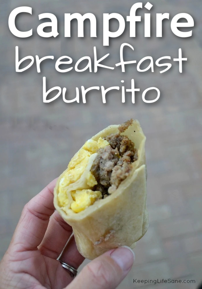 hand holding camping burrito with eggs and ground sausage in tortilla
