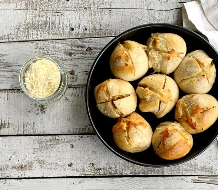 overhead view of round baking pan with garlic bread rolls