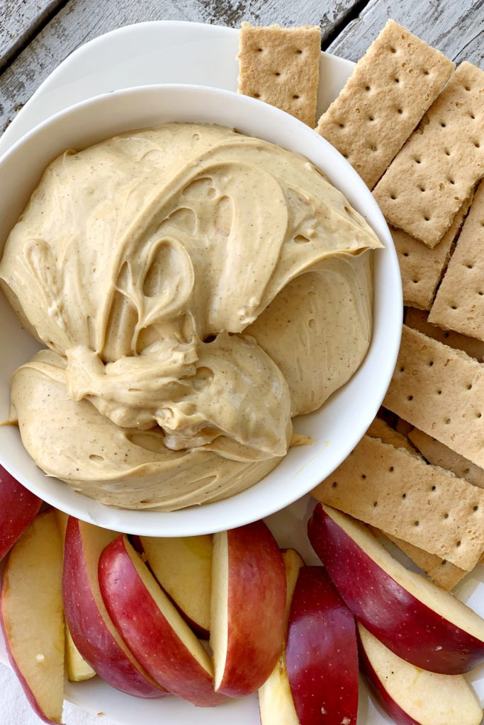 overhead view of gingersnap dip recipe for Christmas with apples and graham crackers