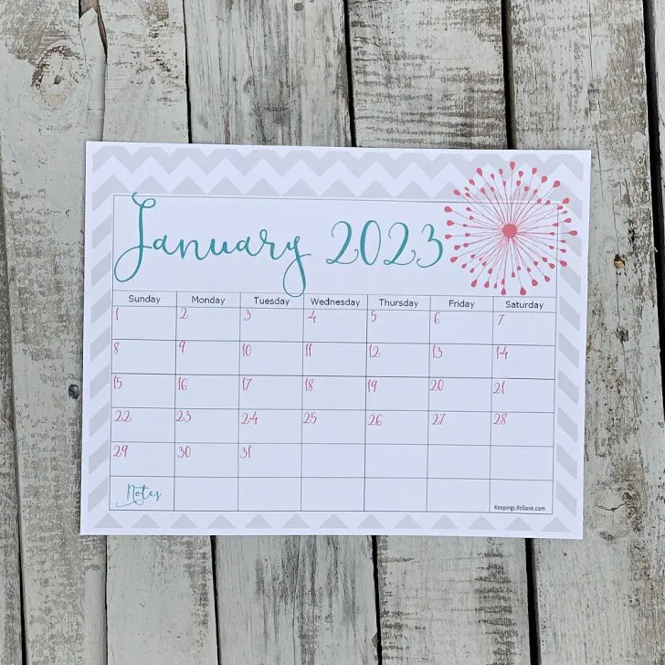 January 2023 calendar laying on wooden table