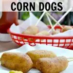 homemade corn dogs on white parchment paper and mustard and ketchup