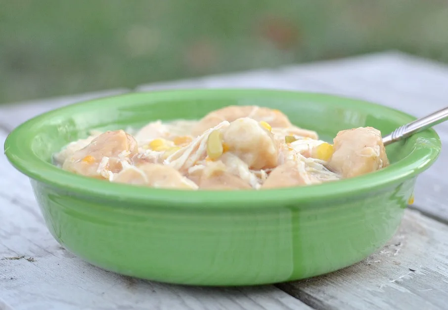 Easy crock pot chicken and dumplings in a green bowl