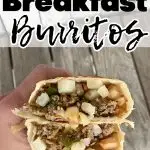 hand holding eggless breakfast burrito cut in half to see ground sausage and hash browns
