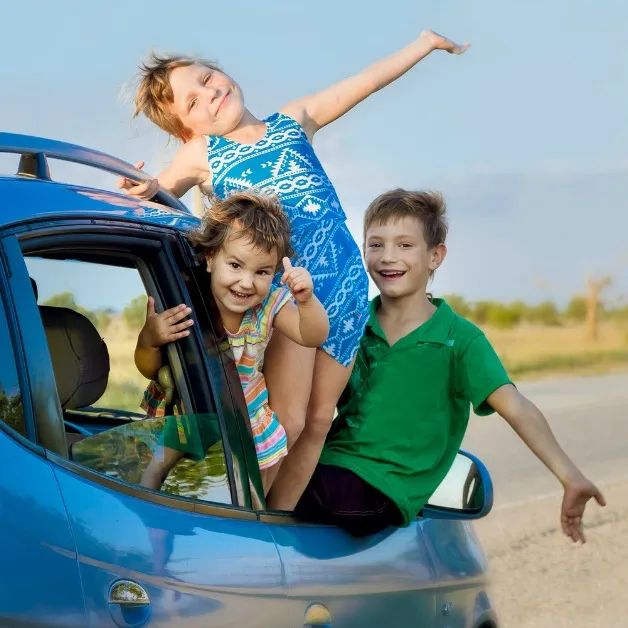three happy kids in car, family trip, summer vacation trave