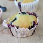 closeup view of no egg blueberry muffin on a wooden cutting board