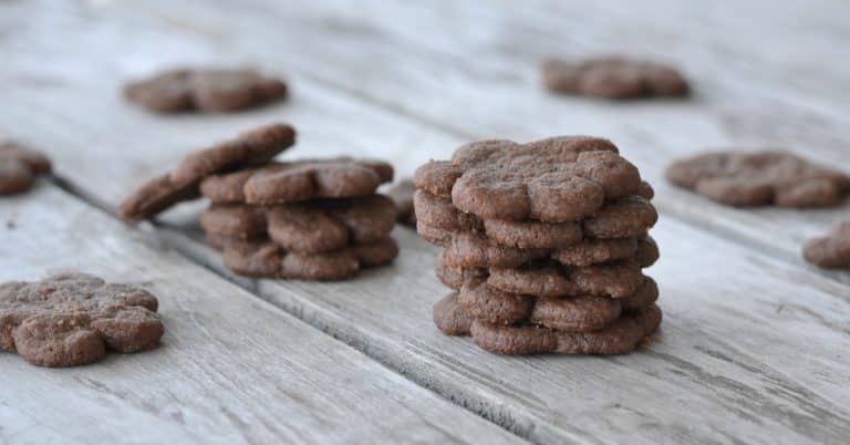 Stack of mini eggless chocolate cookies on wooden table